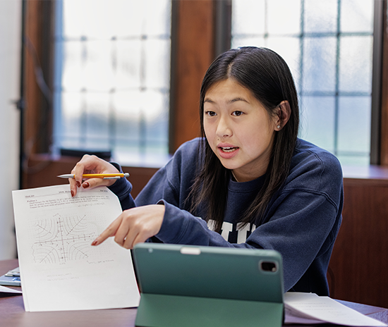 International student in class explaining coursework