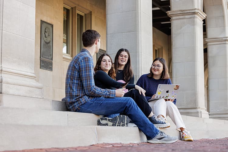 WashU students conversing on steps