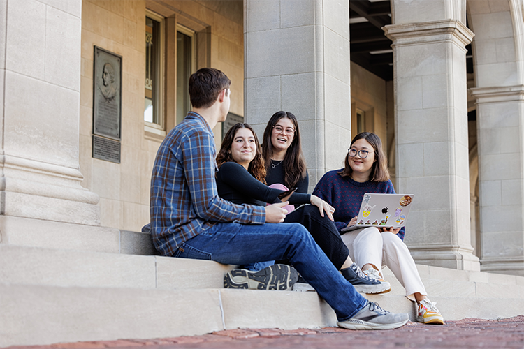 WashU students conversing on steps